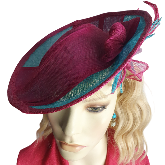 Elegant fascinator hat for women in fuchsia and blue. Handmade from sinamay with abaca silk, for weddings or formal events.