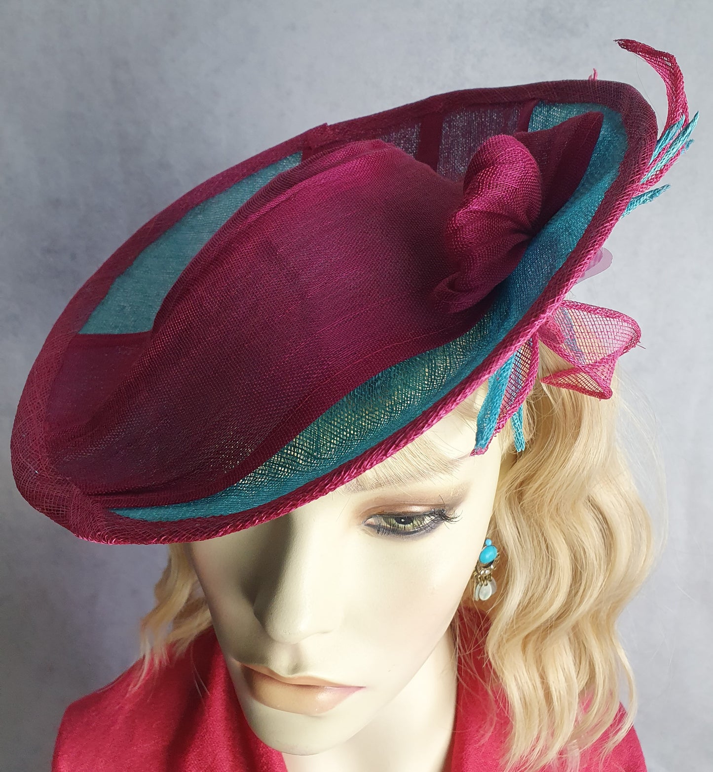 Elegant fascinator hat for women in fuchsia and blue. Handmade from sinamay with abaca silk, for weddings or formal events.