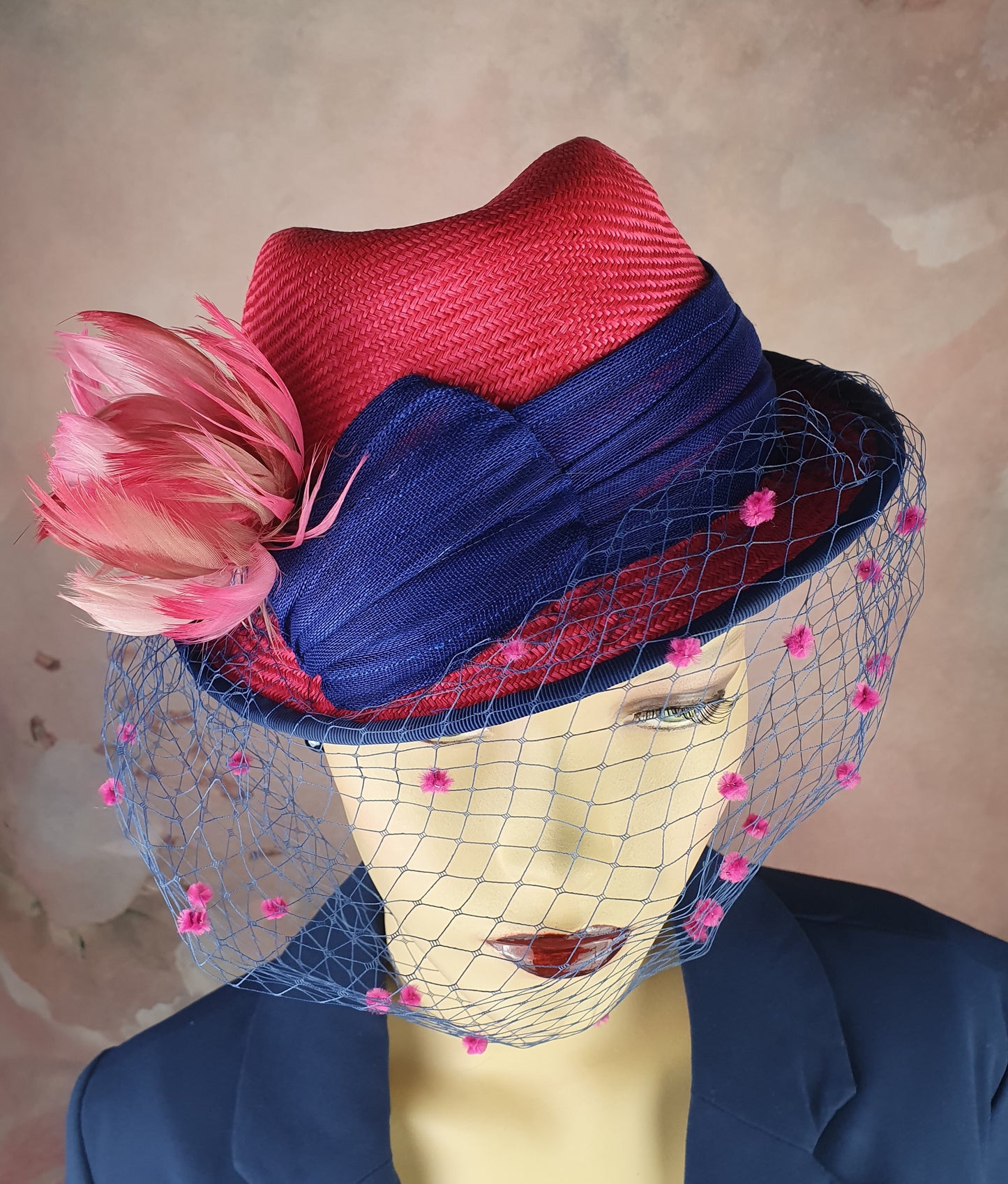 Parasisal ladies hat in the colors fuchsia and blue. Handmade with abacá silk, veil and swan feathers, elegant fascinator hat women