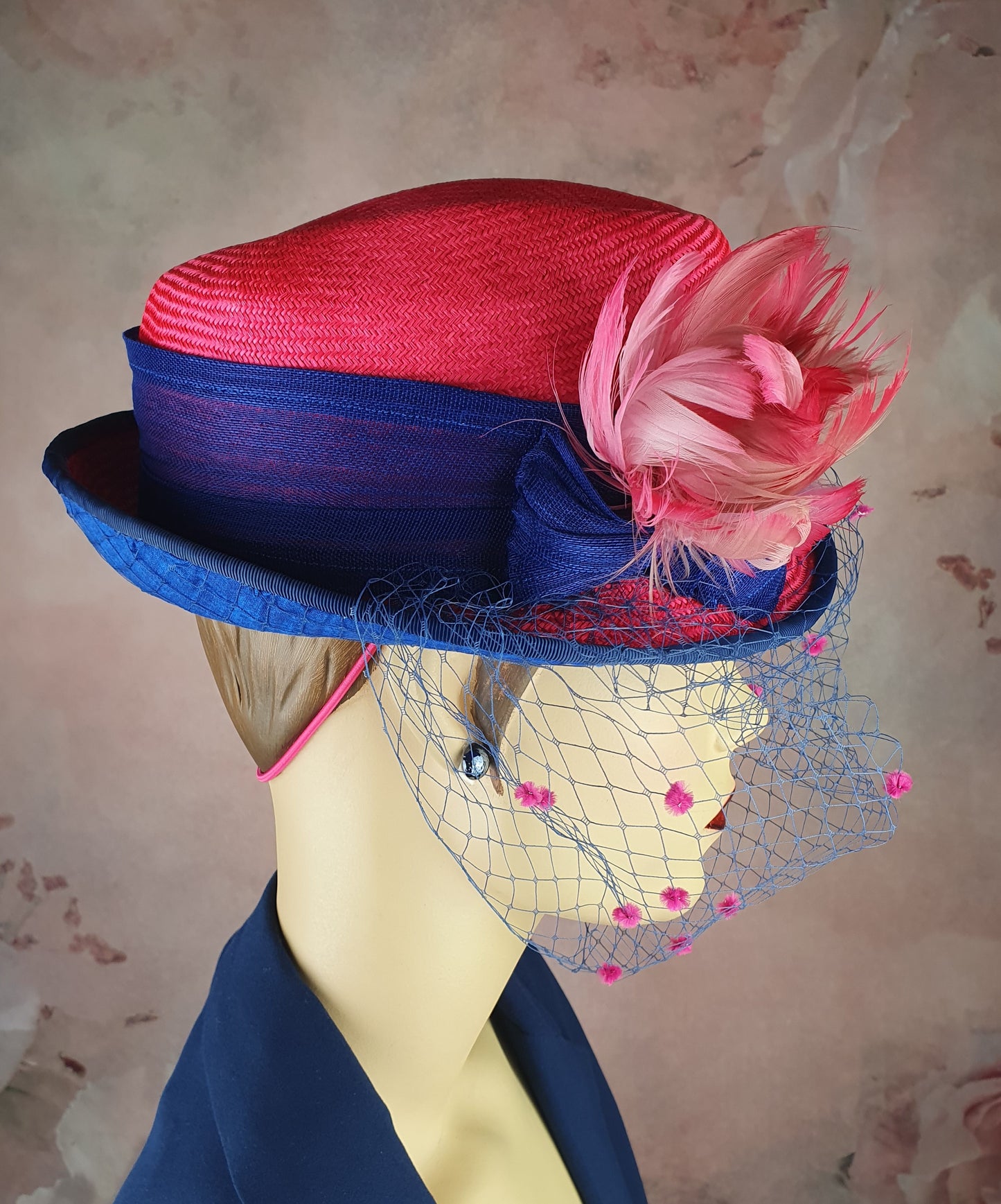 Parasisal ladies hat in the colors fuchsia and blue. Handmade with abacá silk, veil and swan feathers, elegant fascinator hat women